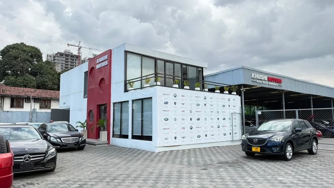 Khushi Motors Dar es Salaam showroom exterior with used Japanese cars on display in Tanzania
